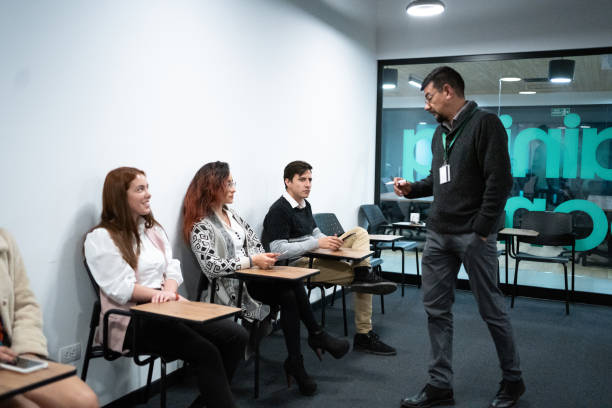 Mature businessman talking to his coworkers or job candidates at office